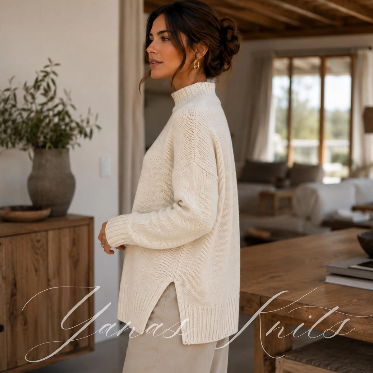 Side view of an ivory longline mock neck sweater showing the side opening and longer back hem